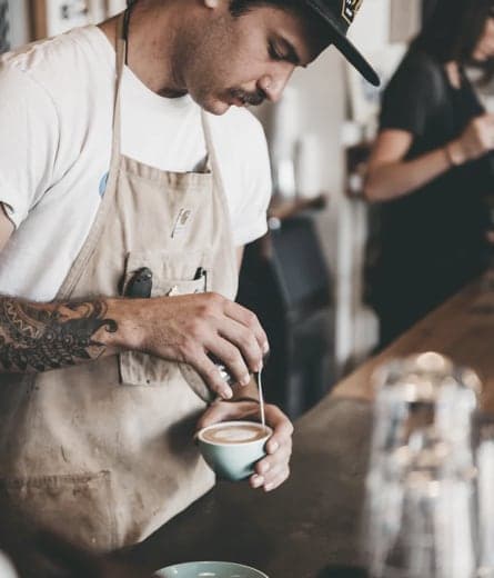 A barista making an artisan coffee