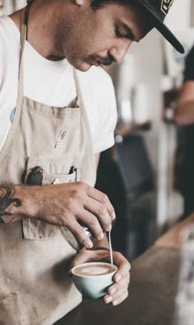 A barista making an artisan coffee