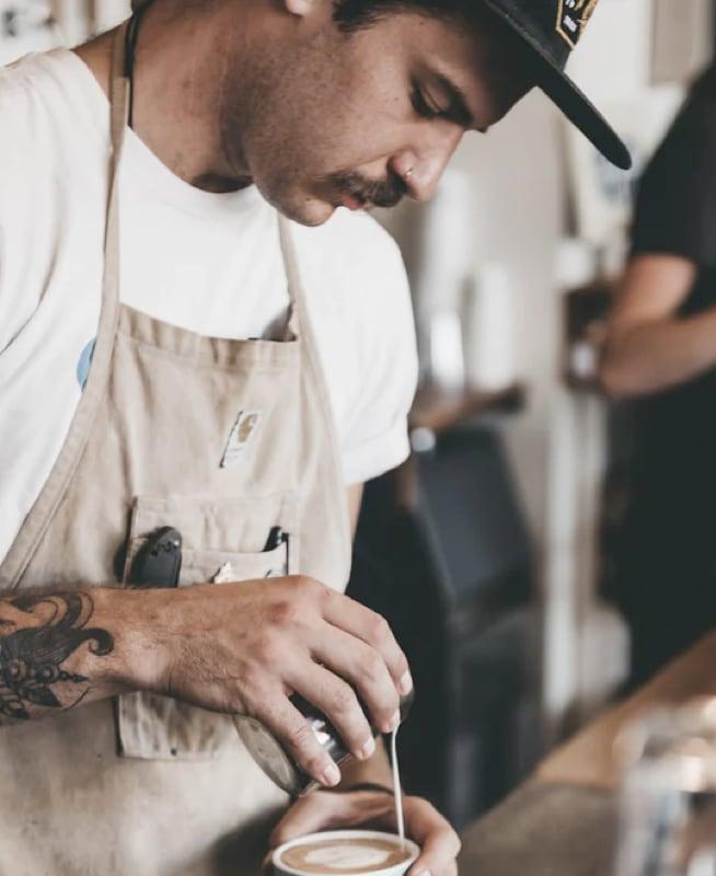 A barista making an artisan coffee